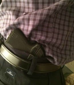 One of the author's PF-11s with the clip installed, and carried via the clip inside his waistband.