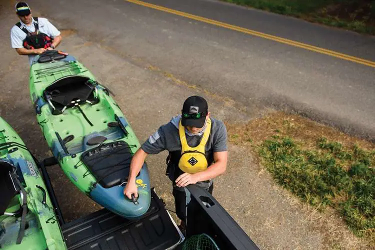 Two Men Carrying Kayak