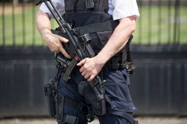 guy standing with rifle on hand