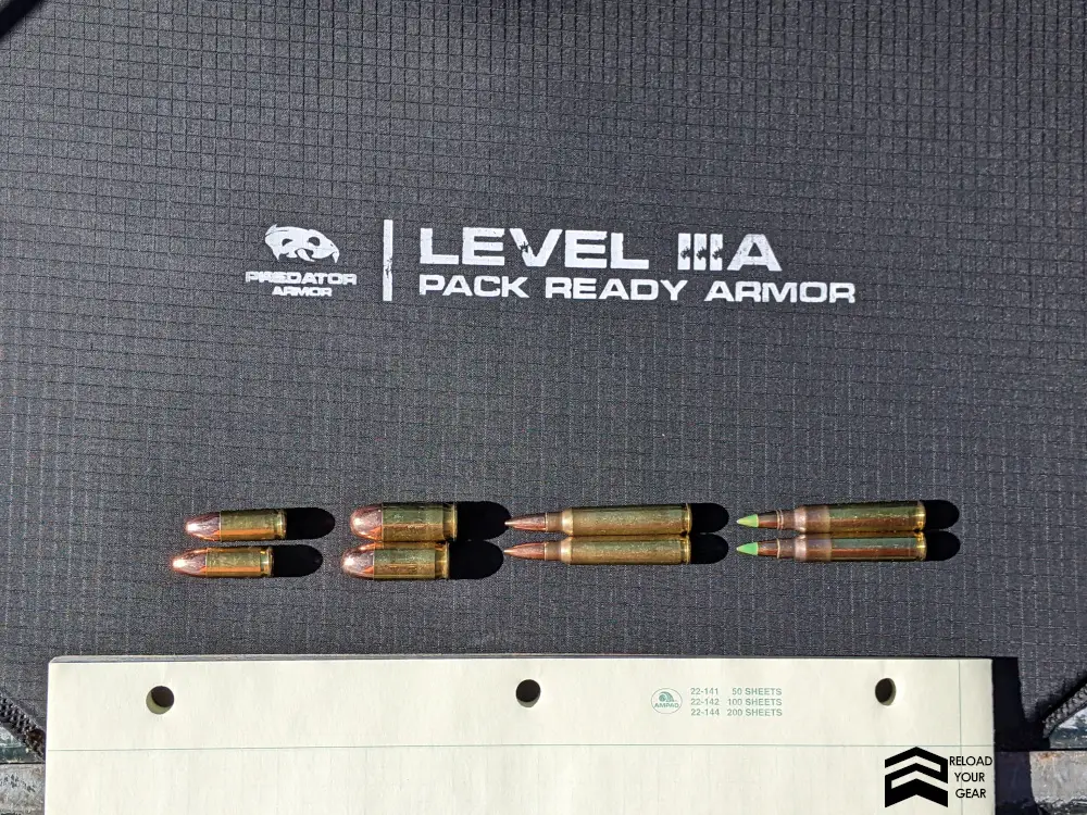9 mm, .45 acp, 5.56 FMJ, and 5.56 M883 Green Tip rounds on a level IIIA armor panel backpack insert